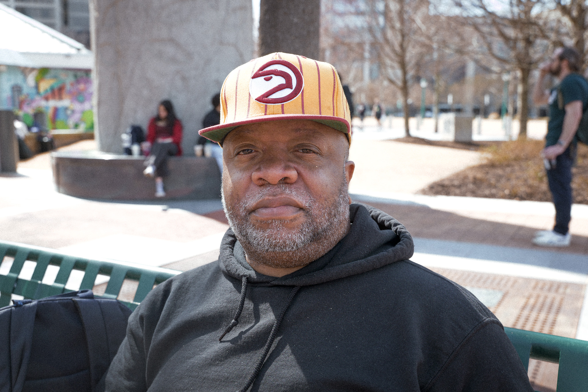 Portrait of a former Tri-Cities High student sitting on a bench in Centennial Olympic Park during an oral history interview about school desegregation.