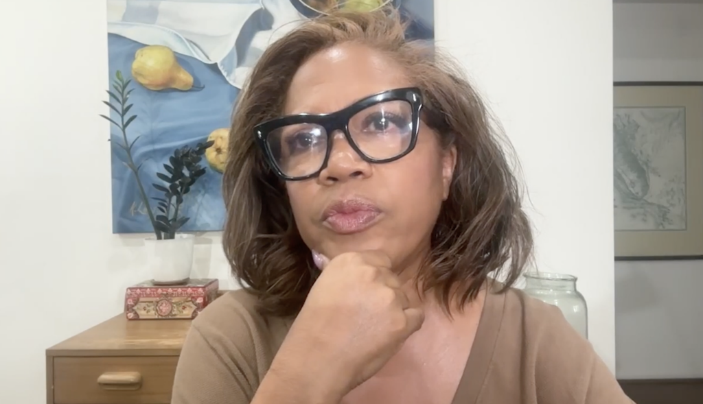 Portrait of journalist and author Danyel Smith wearing black-framed glasses during a video interview.